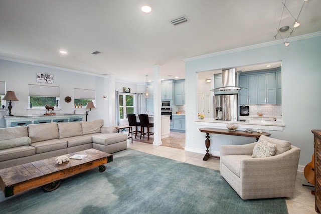 living room featuring light tile patterned floors and ornamental molding