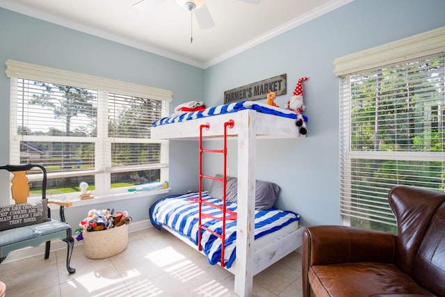 tiled bedroom with ceiling fan and crown molding