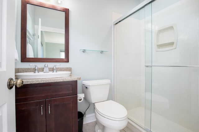 bathroom featuring vanity, toilet, and walk in shower