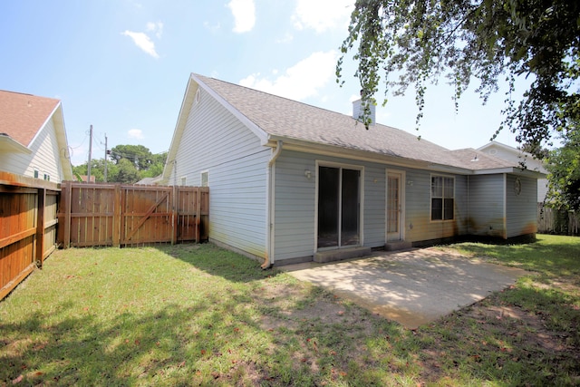 rear view of house with a patio area and a lawn