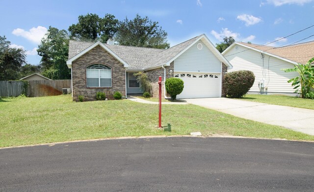 ranch-style home with a front yard and a garage