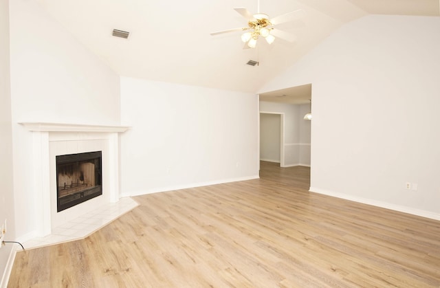 unfurnished living room with ceiling fan, a fireplace, high vaulted ceiling, and light hardwood / wood-style flooring