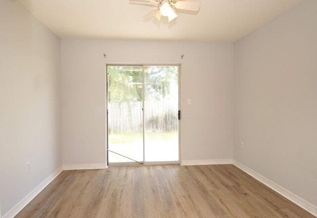 unfurnished room with ceiling fan and light wood-type flooring