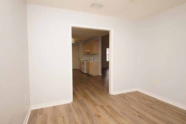 unfurnished room with light hardwood / wood-style floors