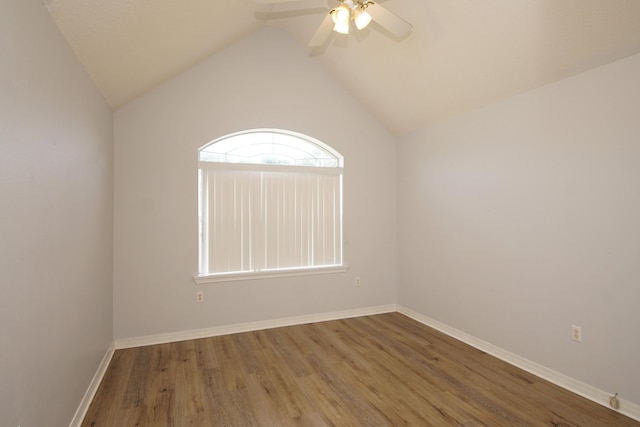 spare room with lofted ceiling, hardwood / wood-style floors, and ceiling fan