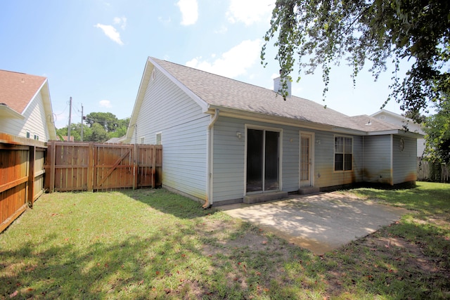 back of property featuring a lawn and a patio