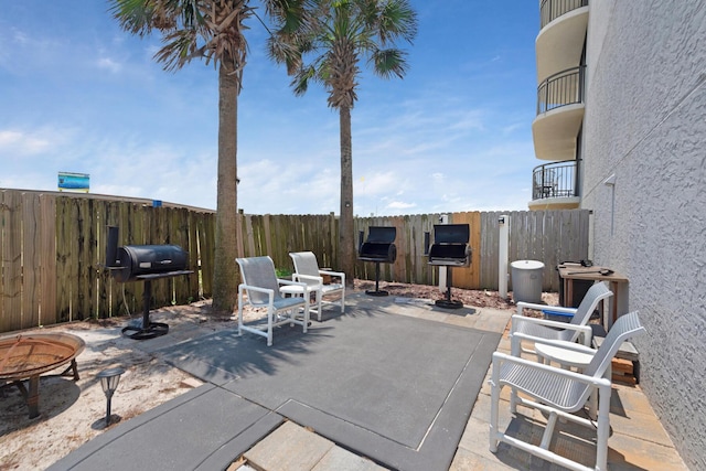 view of patio with an outdoor fire pit