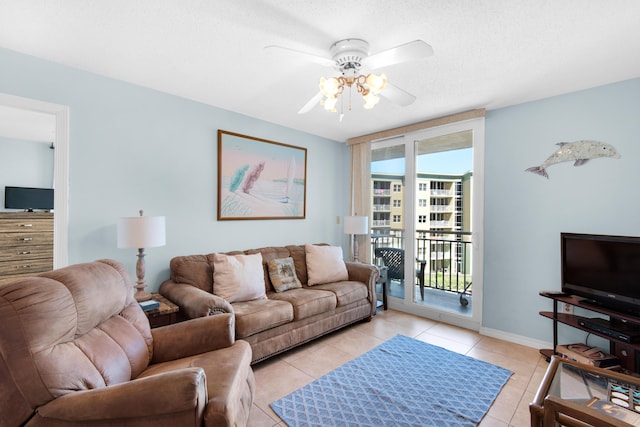 living room with light tile patterned floors, a textured ceiling, and ceiling fan