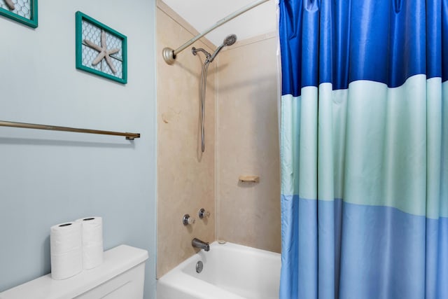 bathroom with shower / tub combo with curtain and toilet