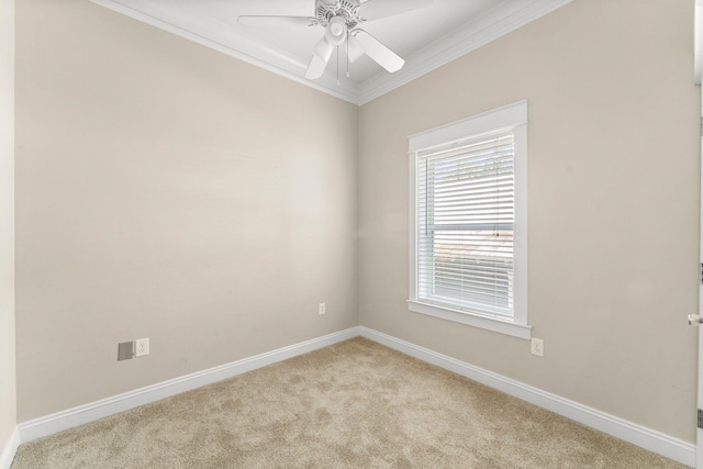 carpeted empty room featuring crown molding and ceiling fan