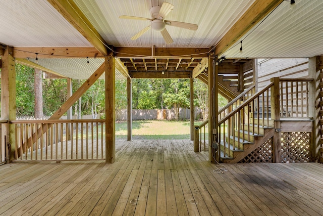 wooden terrace featuring ceiling fan and a yard