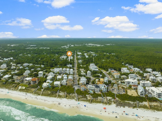 birds eye view of property with a water view and a beach view