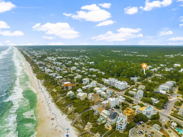 birds eye view of property featuring a water view and a beach view