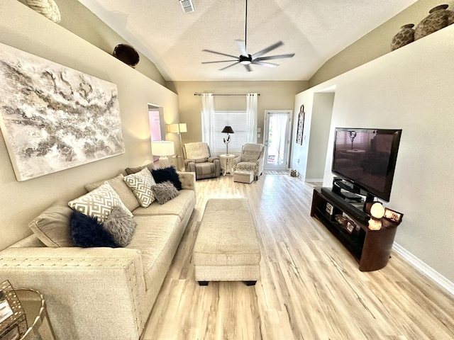 living room with lofted ceiling, a textured ceiling, ceiling fan, and light hardwood / wood-style floors