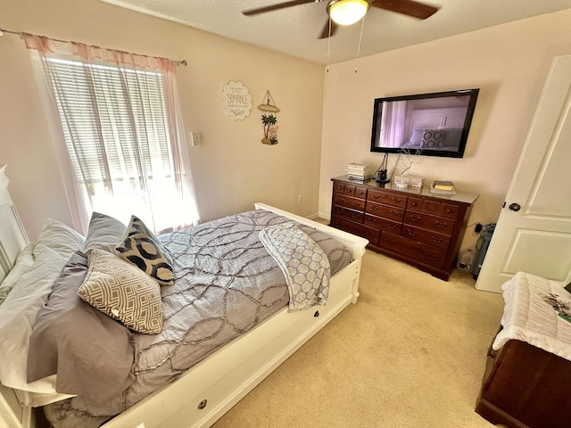 bedroom with ceiling fan and light colored carpet