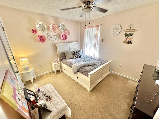 bedroom with a textured ceiling, ceiling fan, and light colored carpet