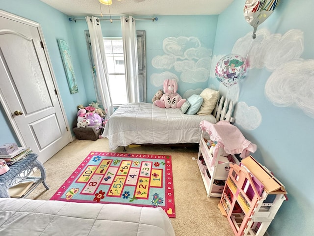 bedroom with a textured ceiling and light colored carpet