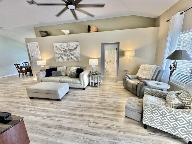 living room with lofted ceiling, ceiling fan, and light hardwood / wood-style flooring