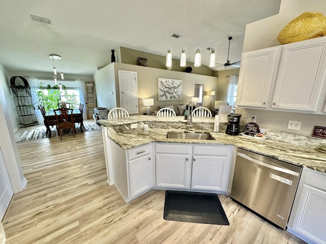 kitchen featuring sink, white cabinetry, dishwasher, and hanging light fixtures