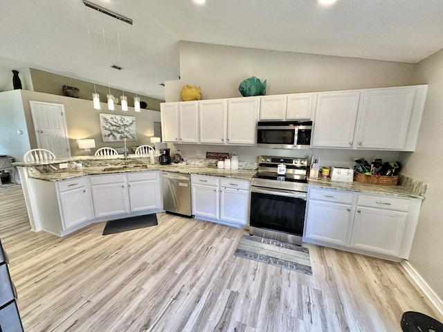 kitchen with kitchen peninsula, pendant lighting, stainless steel appliances, light hardwood / wood-style floors, and white cabinets