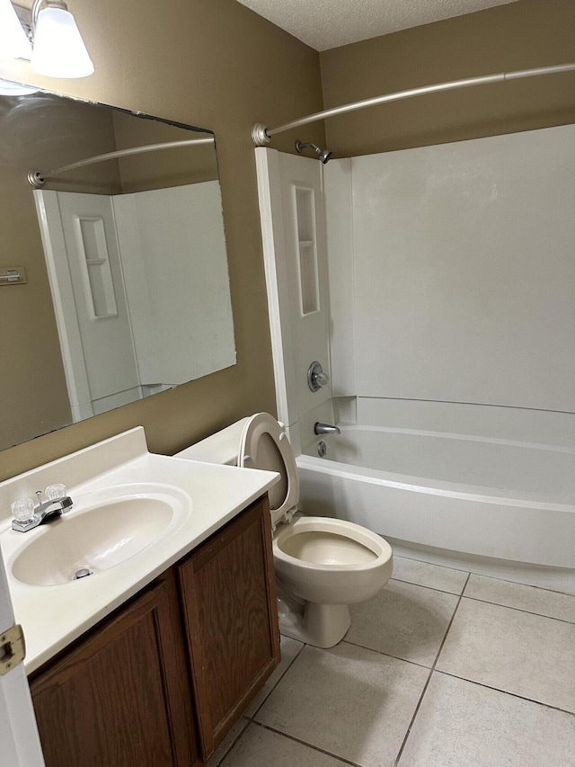 full bathroom featuring bathing tub / shower combination, tile patterned floors, vanity, and a textured ceiling