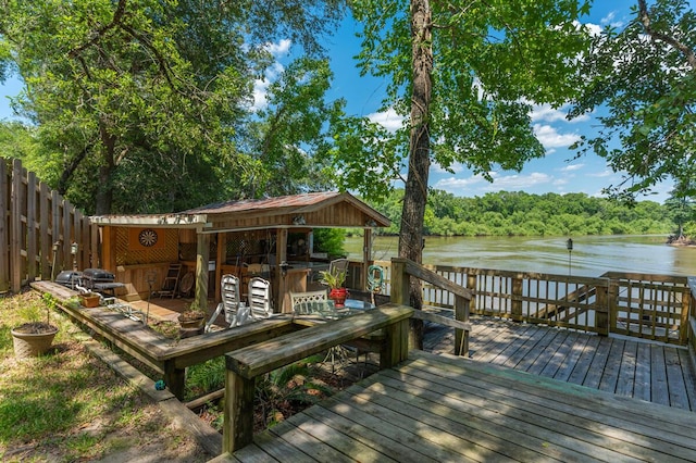 dock area featuring a deck with water view and exterior bar