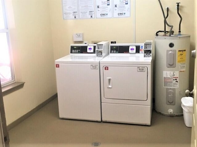 shared laundry area featuring electric water heater, washer and clothes dryer, and baseboards