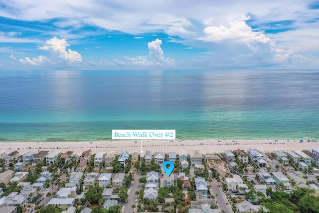 birds eye view of property with a view of the beach and a water view