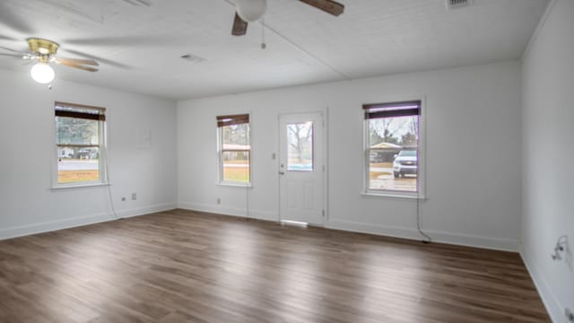 interior space with ceiling fan and dark hardwood / wood-style flooring