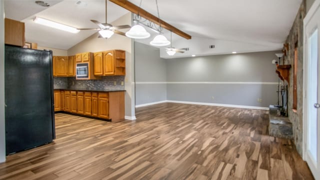 kitchen featuring black refrigerator, ceiling fan, backsplash, wood-type flooring, and lofted ceiling with beams