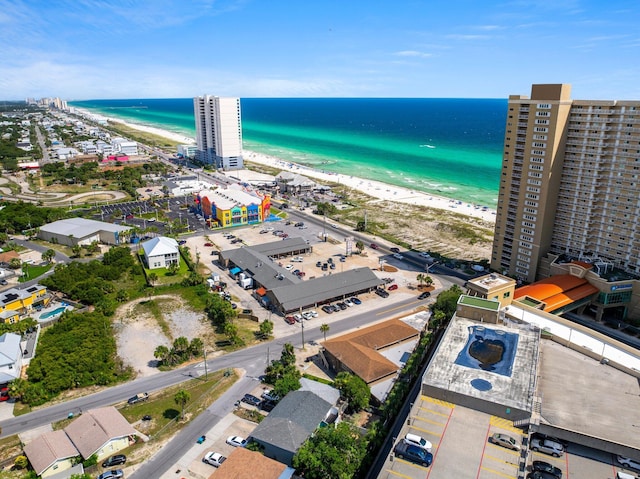 birds eye view of property with a water view and a beach view