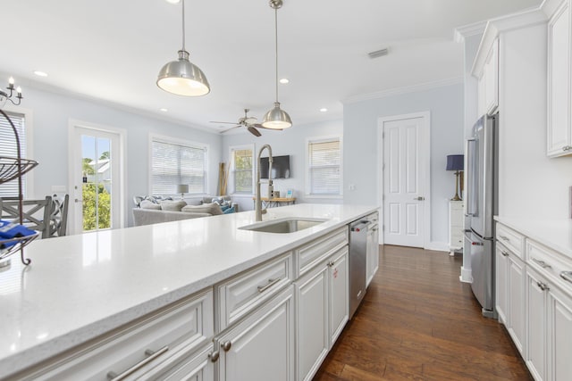 kitchen with decorative light fixtures, white cabinets, stainless steel appliances, and dark hardwood / wood-style floors