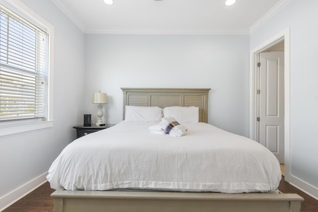 bedroom with dark hardwood / wood-style floors, multiple windows, and crown molding