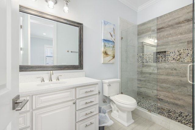 bathroom with vanity, toilet, ornamental molding, and walk in shower