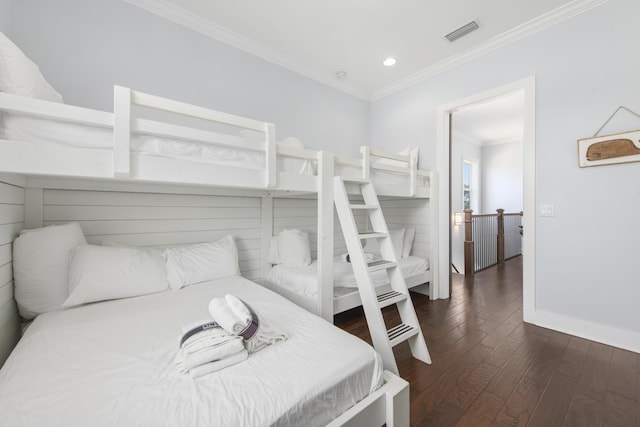 bedroom with dark hardwood / wood-style flooring and ornamental molding