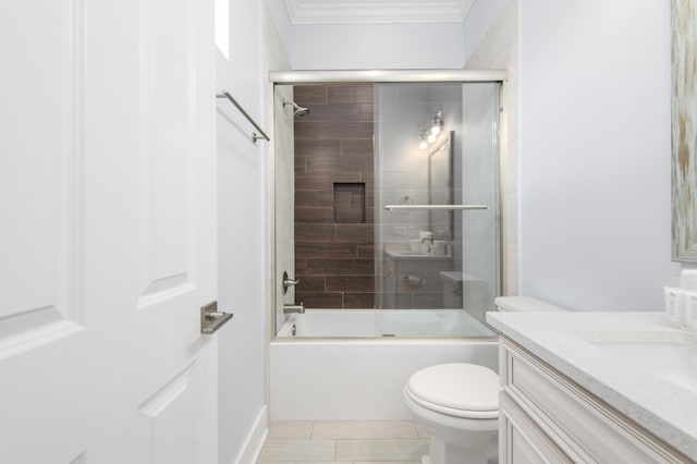 full bathroom with vanity, toilet, shower / bath combination with glass door, and ornamental molding