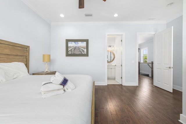 bedroom featuring dark wood-type flooring, ensuite bathroom, ceiling fan, and crown molding