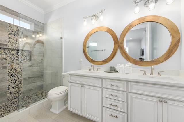 bathroom featuring tiled shower, vanity, toilet, and ornamental molding