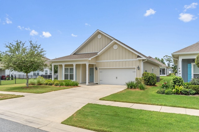 view of front of property with a garage and a front lawn