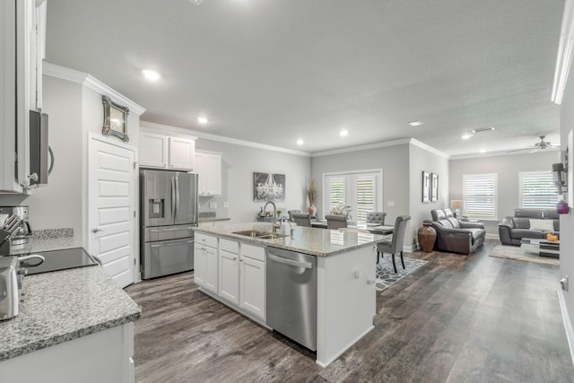 kitchen featuring plenty of natural light, white cabinetry, and appliances with stainless steel finishes