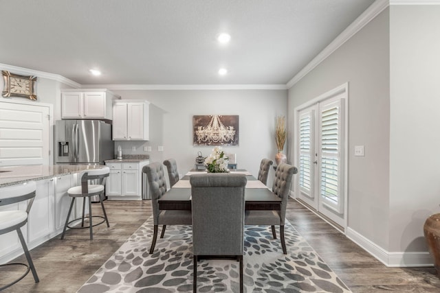 dining area featuring dark hardwood / wood-style flooring and ornamental molding