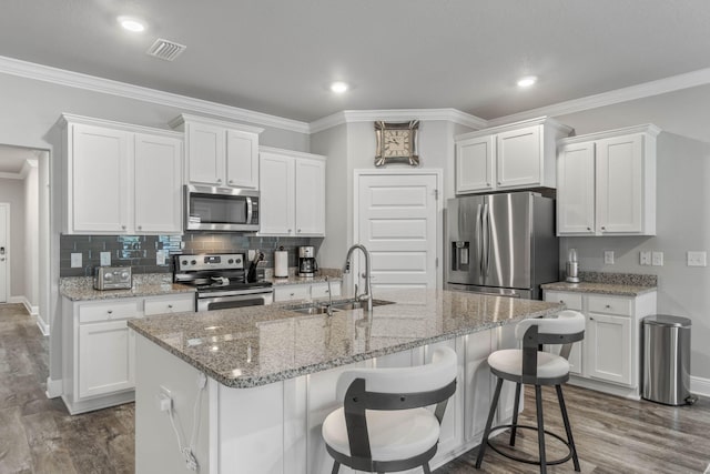 kitchen with white cabinetry, sink, appliances with stainless steel finishes, and dark wood-type flooring