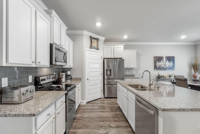 kitchen featuring sink, white cabinets, hardwood / wood-style floors, and appliances with stainless steel finishes