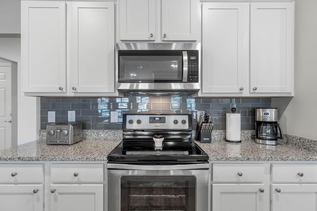 kitchen with white cabinetry and appliances with stainless steel finishes