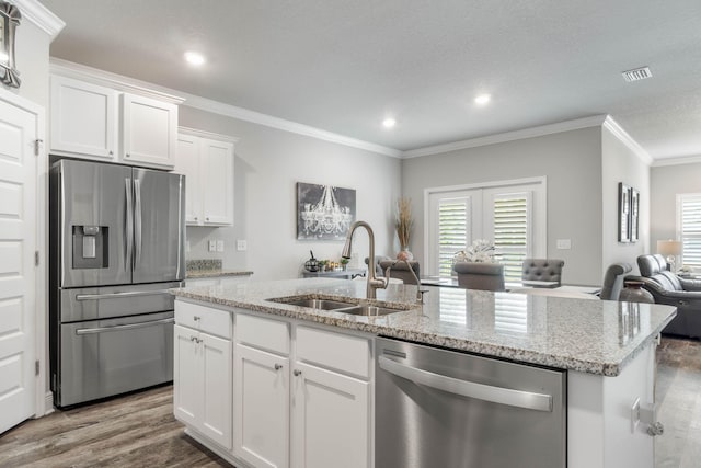 kitchen featuring stainless steel appliances, white cabinetry, ornamental molding, and sink