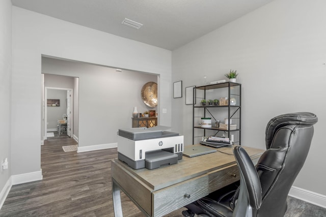 home office with dark hardwood / wood-style flooring