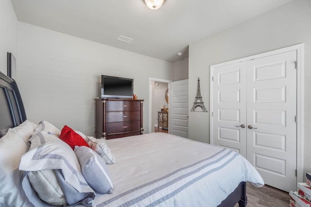 bedroom featuring hardwood / wood-style floors and a closet