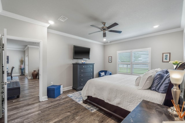 bedroom featuring a textured ceiling, ceiling fan, dark hardwood / wood-style floors, and crown molding