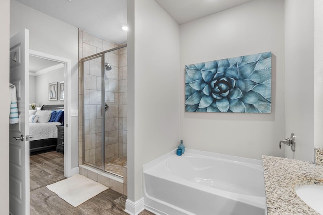 bathroom with vanity, independent shower and bath, and hardwood / wood-style flooring