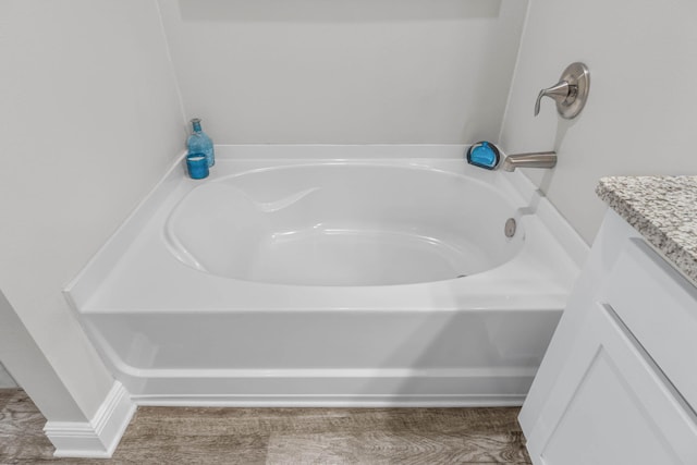 bathroom with vanity and a tub